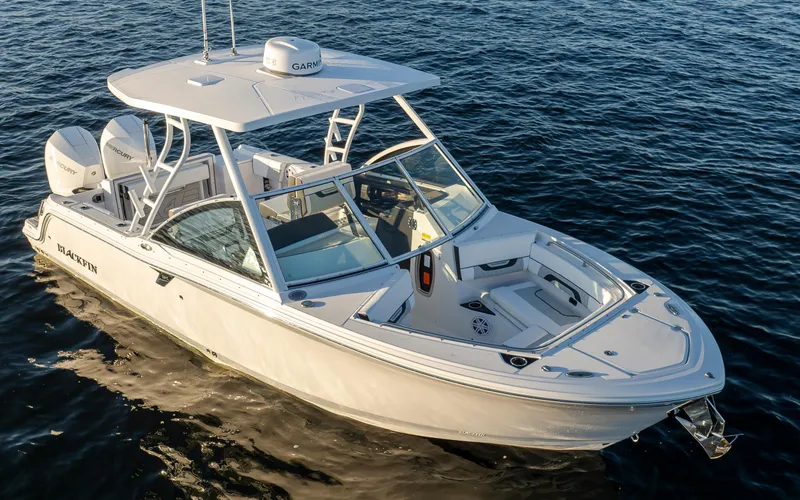 Slide: The Image of A sleek, modern boat on calm water. It features a spacious deck and two outboard engines. - 3
