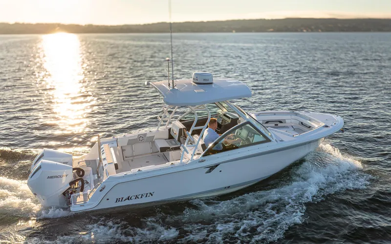 Slide: The Image of A 2027 Blackfin 252 DC boat cruising on calm waters at sunset. - 5