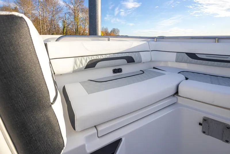 Slide: The Image of Interior seating of 2024 Blackfin 252 DC boat with white and gray upholstery. - 11