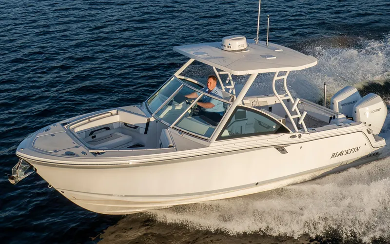 Slide: The Image of A modern 2027 Blackfin 252 DC speeds across the water, featuring a white hull and spacious deck. - 43