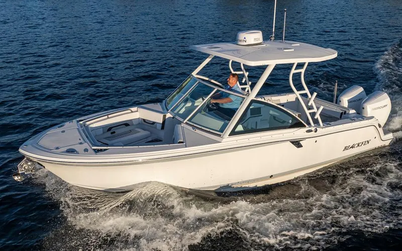Slide: The Image of A modern white Blackfin 252 DC boat cruising on calm water. It features a spacious deck and hardtop. - 6