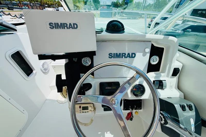 Slide: The Image of Helm of 2006 Glacier Bay 2670 Isle Runner with Simrad navigation system and steering wheel. - 14