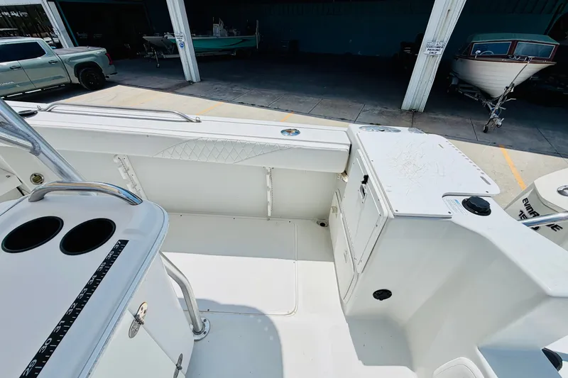 Slide: The Image of 2006 Glacier Bay 2670 Isle Runner boat interior with storage and seating area. - 8