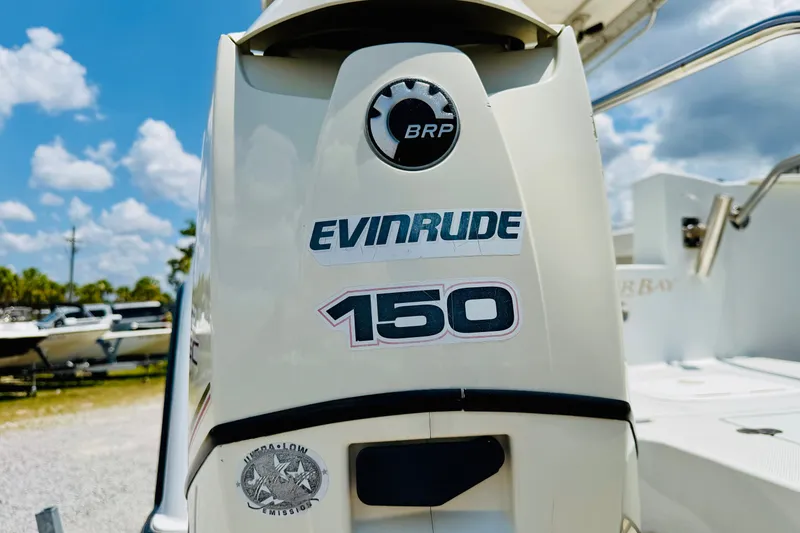 Slide: The Image of Evinrude 150 engine on 2006 Glacier Bay 2670 Isle Runner boat, sunny day background. - 32