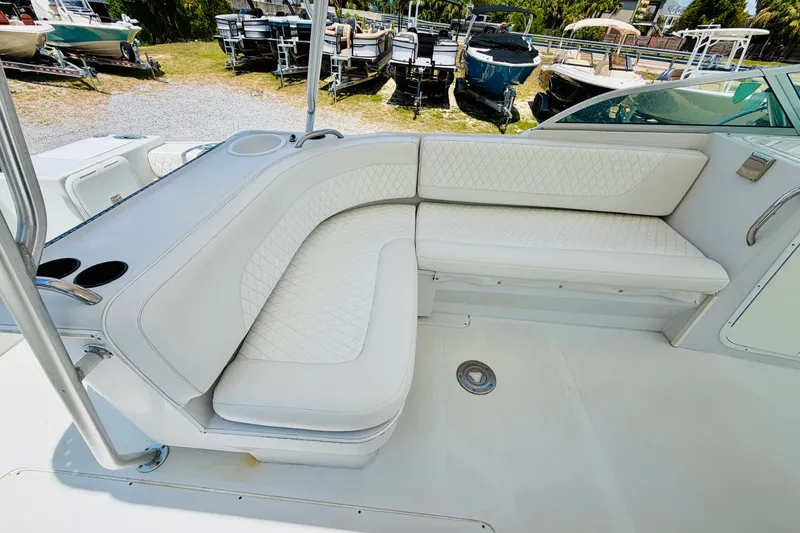 Slide: The Image of 2006 Glacier Bay 2670 Isle Runner boat interior with white cushioned seating. - 11