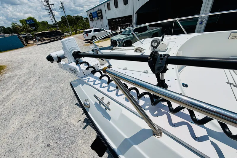 Slide: The Image of 2006 Glacier Bay 2670 Isle Runner boat with trolling motor in a marina setting. - 24