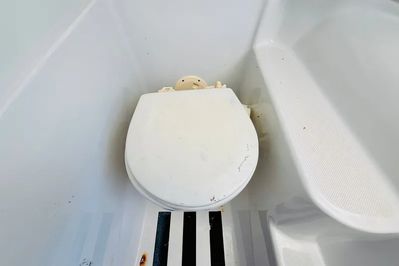 Slide: The Image of Boat toilet in a 2006 Glacier Bay 2670 Isle Runner, white interior. - 27