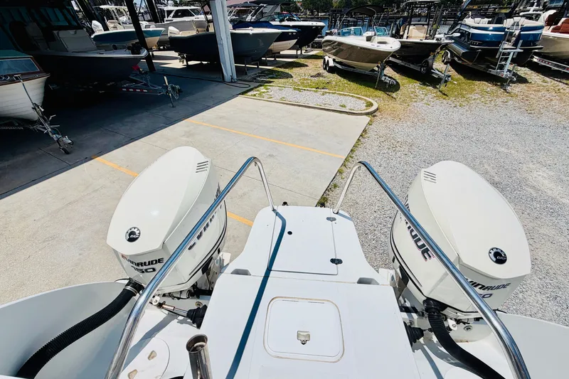 Slide: The Image of 2006 Glacier Bay 2670 Isle Runner with dual Evinrude engines in a boatyard. - 7