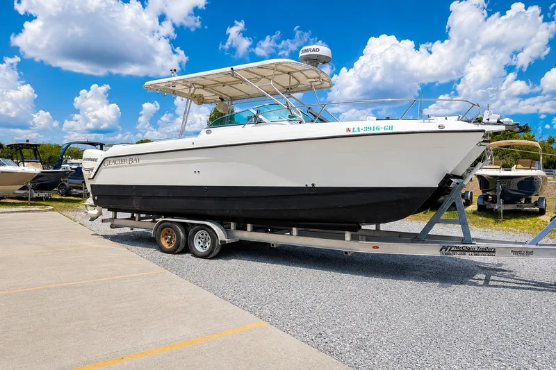 Slide: The Image of 2006 Glacier Bay 2670 Isle Runner boat on trailer under blue sky. - 2