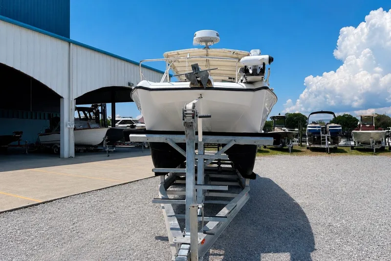 Slide: The Image of 2006 Glacier Bay 2670 Isle Runner boat on trailer at marina under blue sky. - 1