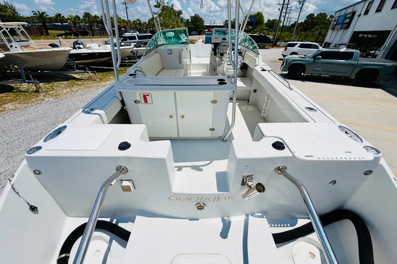 Slide: The Image of 2006 Glacier Bay 2670 Isle Runner boat interior with seating and storage compartments. - 6
