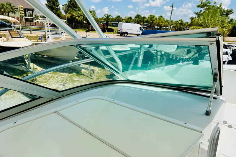 Slide: The Image of 2006 Glacier Bay 2670 Isle Runner boat windshield and deck, sunny marina setting. - 30