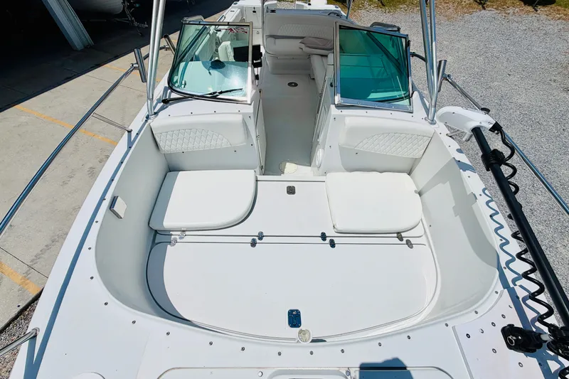 Slide: The Image of 2006 Glacier Bay 2670 Isle Runner boat interior with white seating and windshield. - 21