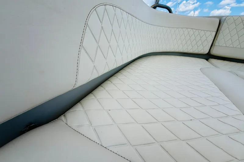 Slide: The Image of Luxurious white seating on 2006 Glacier Bay 2670 Isle Runner boat, featuring diamond stitching. - 12