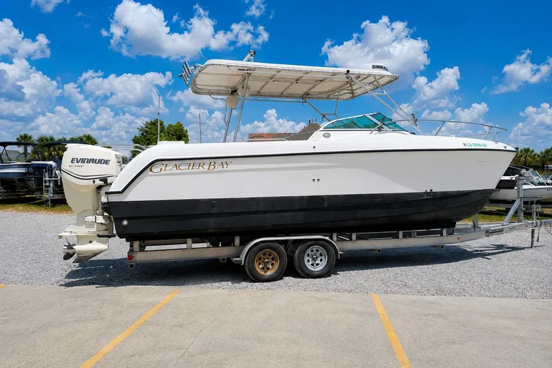 Slide: The Image of 2006 Glacier Bay 2670 Isle Runner boat on trailer under blue sky. - 3