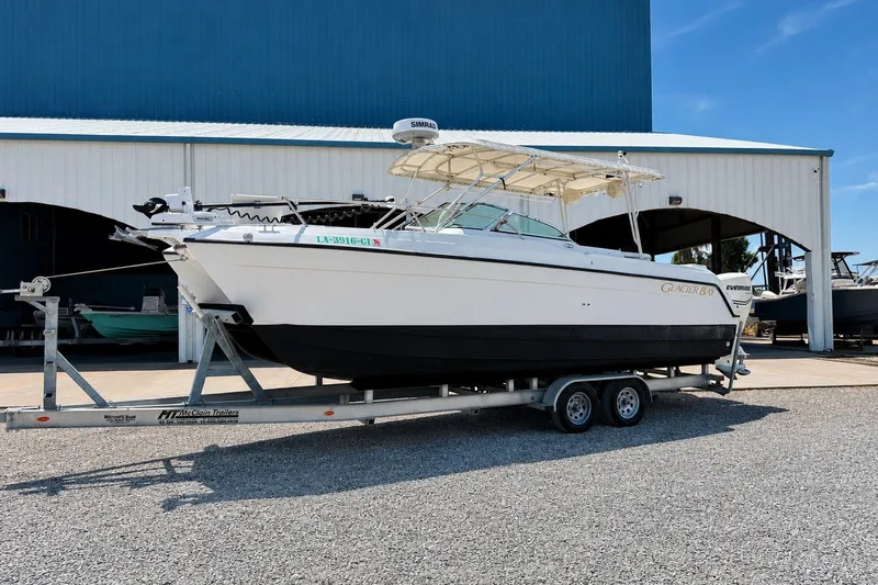 The Image of 2006 Glacier Bay 2670 Isle Runner boat on trailer outside storage facility. - 0