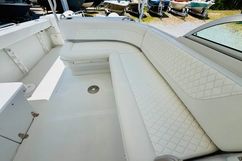 Slide: The Image of 2006 Glacier Bay 2670 Isle Runner boat interior with white cushioned seating. - 16