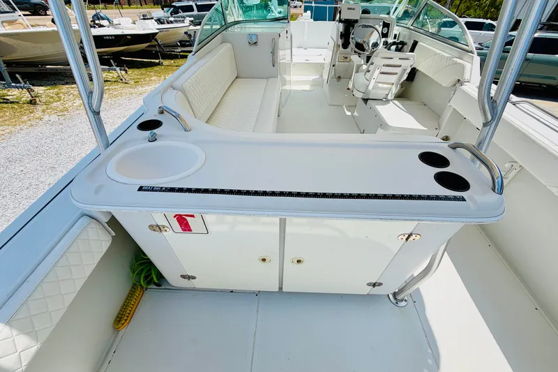 Slide: The Image of 2006 Glacier Bay 2670 Isle Runner boat interior with seating and helm station. - 10