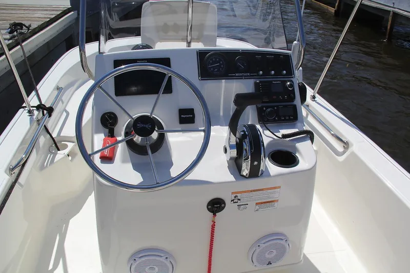 Slide: The Image of Manufacturer Provided Image: 2018 Boston Whaler 150 Montauk boat console with steering wheel and controls. - 10
