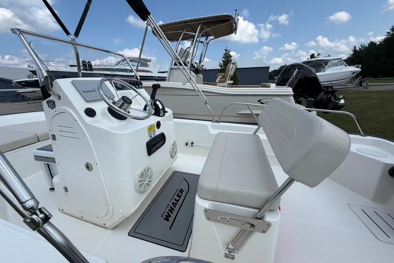 Slide: The Image of 2018 Boston Whaler 150 Montauk boat interior with steering console and seating. - 3