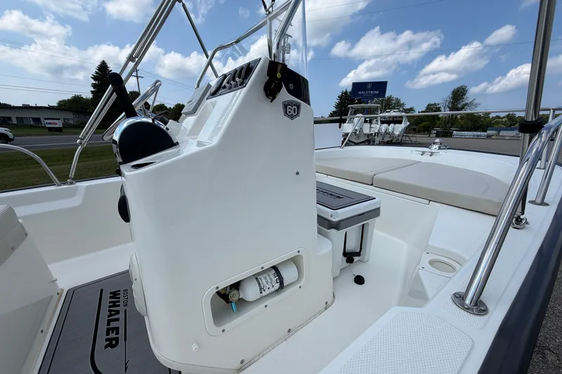 Slide: The Image of 2018 Boston Whaler 150 Montauk boat interior with steering console and seating. - 5