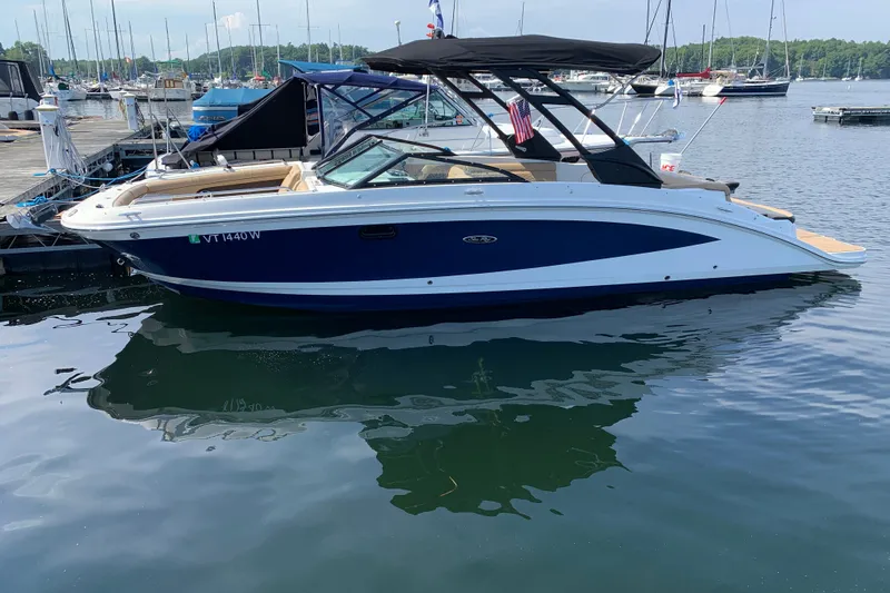 The Image of 2022 Sea Ray SDX 270 boat docked at marina, featuring sleek design and blue hull. - 0