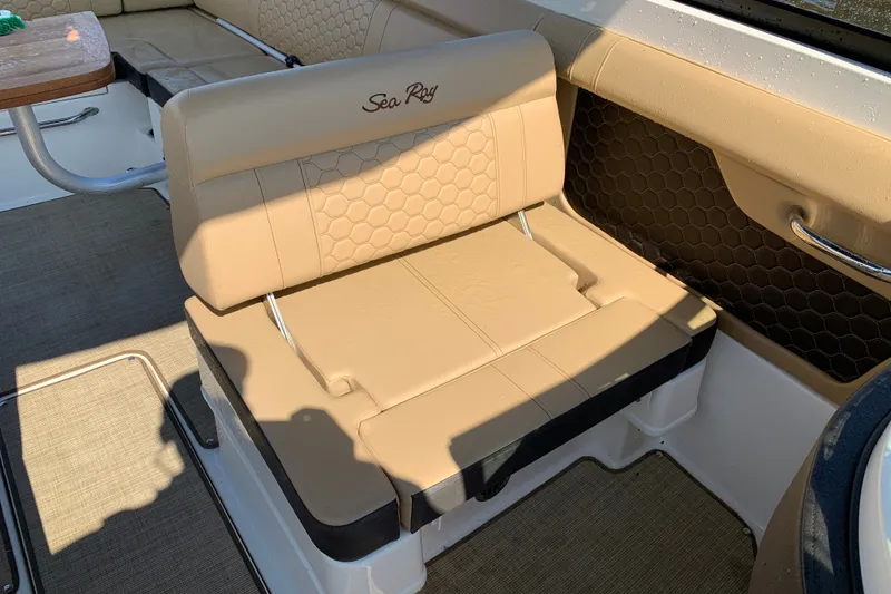 Slide: The Image of 2022 Sea Ray SDX 270 boat interior with beige seating and honeycomb pattern. - 17