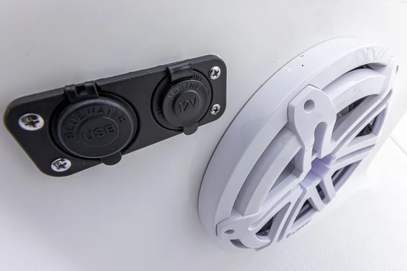 Slide: The Image of Close-up of a USB and 12V outlet next to a speaker on a boat. - 17