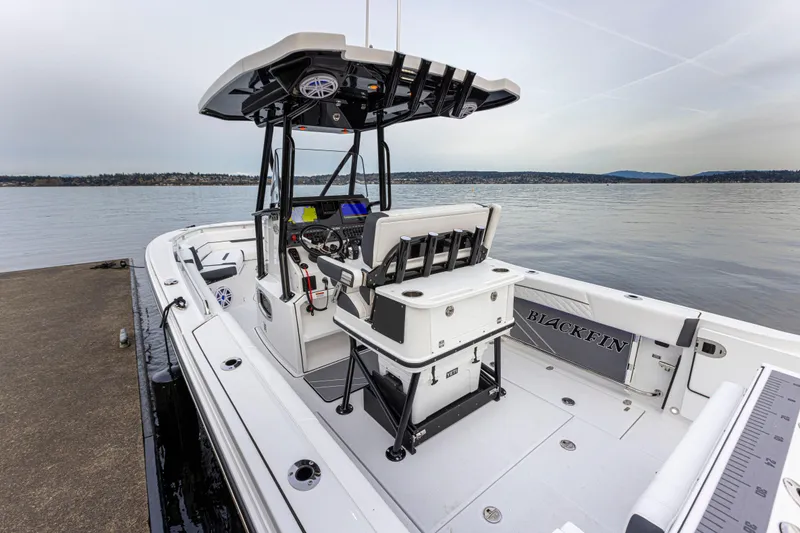 Slide: The Image of A modern 2027 Blackfin 252 CC docked. It features a spacious cockpit and sturdy T-top structure. - 21