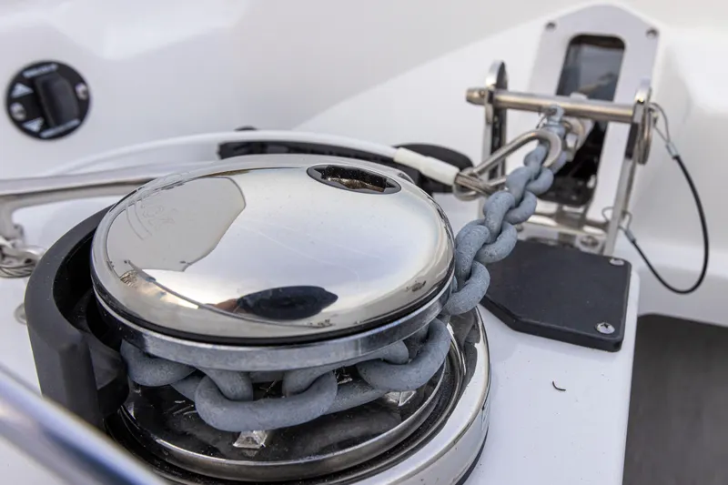 Slide: The Image of Close-up of an anchor windlass with chain on a boat, surrounded by white deck. - 14