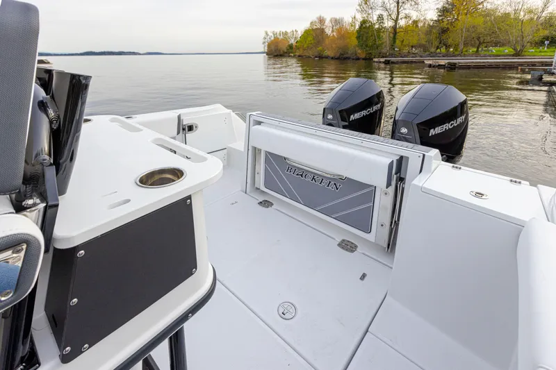 Slide: The Image of The image shows the stern of a Blackfin 252 CC boat with two Mercury engines. - 7