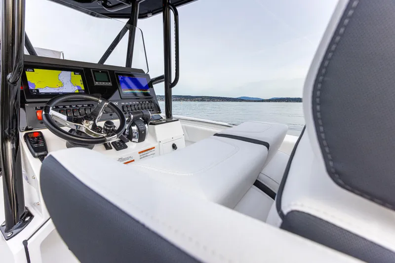 Slide: The Image of The cockpit of a 2027 Blackfin 252 CC with modern navigation systems and comfortable seating. - 6