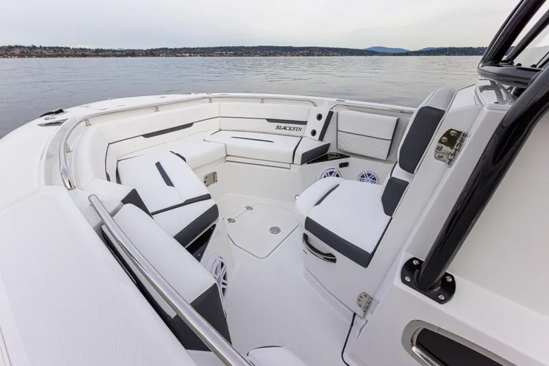 Slide: The Image of The image shows the cockpit of a 2027 Blackfin 252 CC boat with white and gray seating. - 19