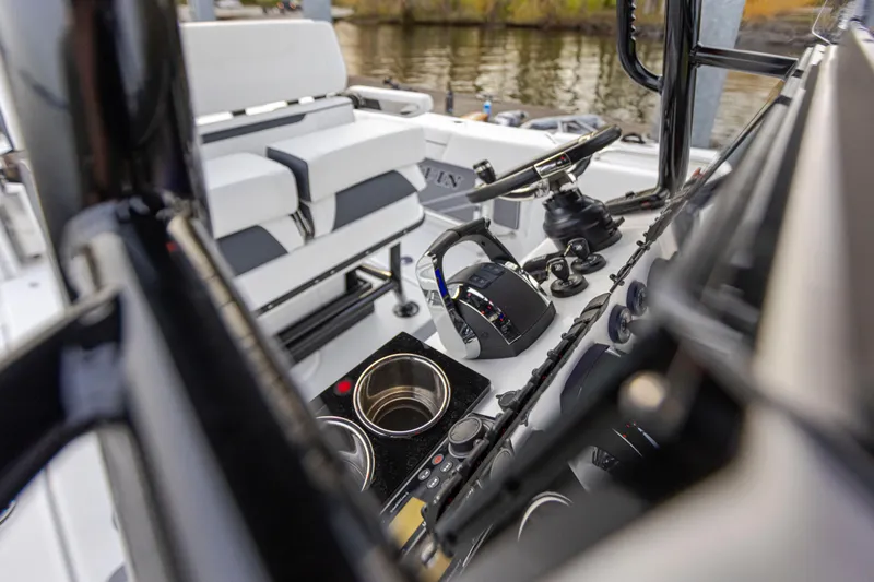 Slide: The Image of The image shows the cockpit of a 2027 Blackfin 252 CC boat with modern controls and cup holders. - 4