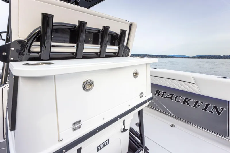 Slide: The Image of The image shows the stern of a Blackfin 252 CC boat with rod holders and a Yeti cooler. - 8