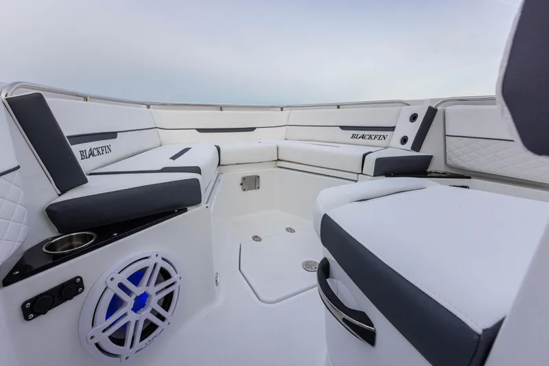 Slide: The Image of The image shows the cockpit of a Blackfin 252 CC boat with white and black seating. - 18