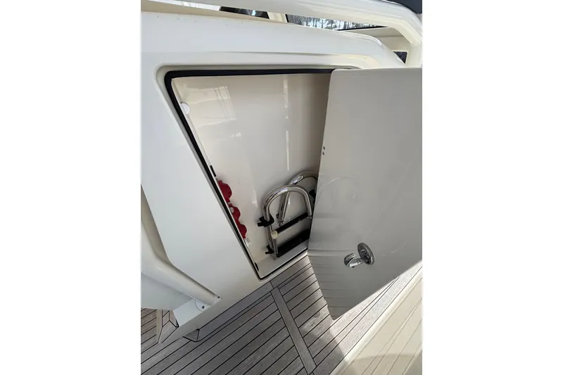 Slide: The Image of Open storage compartment on 2018 Ocean 1 R boat with visible ladder and equipment. - 9