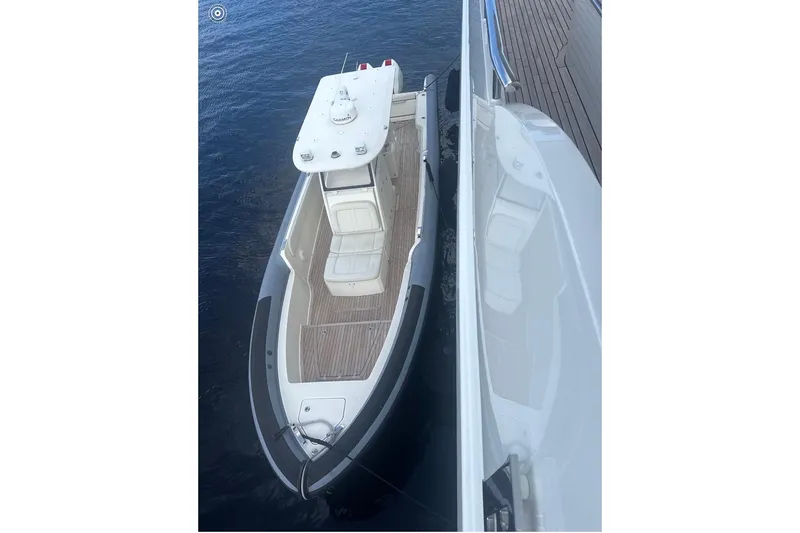 Slide: The Image of Aerial view of 2018 Ocean 1 R boat docked beside a larger vessel. - 4