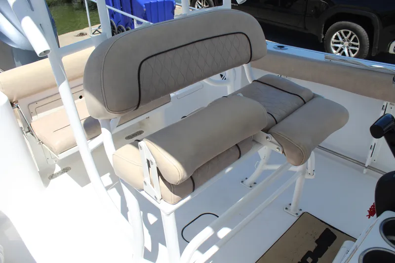 Slide: The Image of The 2019 Sportsman Open 232 Center Console features cushioned seating and a white console. - 14