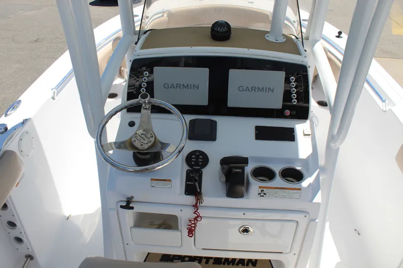 Slide: The Image of The image shows the helm of a 2019 Sportsman Open 232 Center Console boat with Garmin screens. - 17