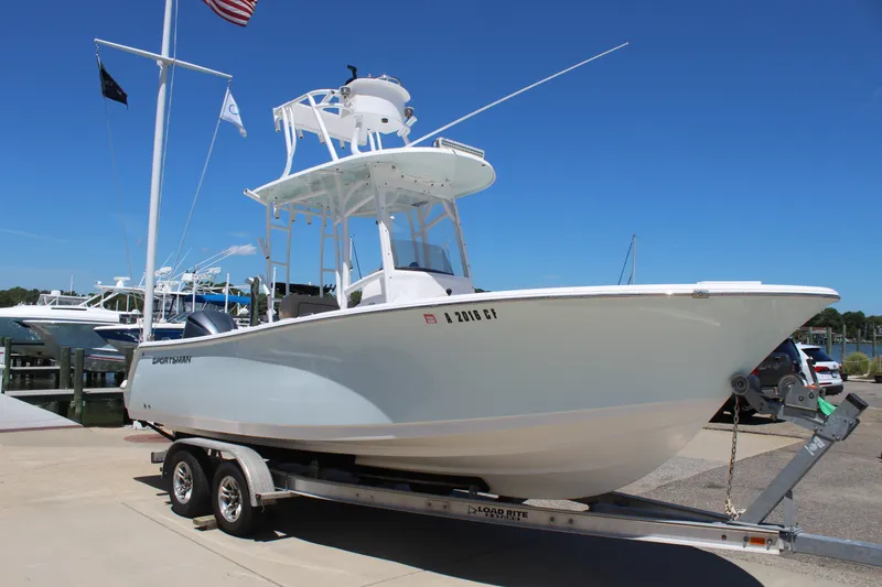 Slide: The Image of A 2019 Sportsman Open 232 Center Console boat on a trailer, ready for launch. - 8