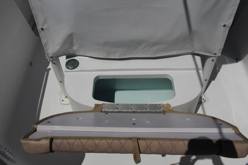 Slide: The Image of An open storage compartment on a 2019 Sportsman Open 232 Center Console boat. - 21