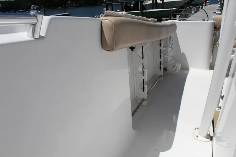 Slide: The Image of The image shows the deck of a 2019 Sportsman Open 232 Center Console boat with a bench seat. - 24