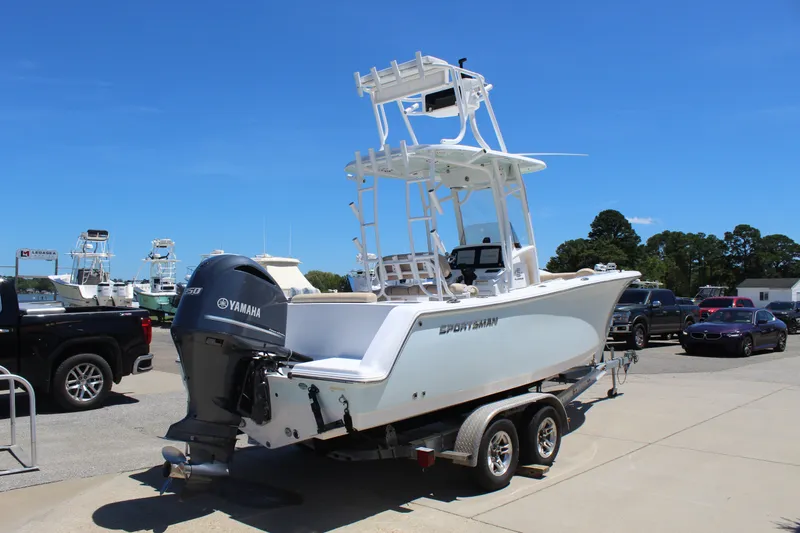 Slide: The Image of A 2019 Sportsman Open 232 Center Console boat on a trailer in a parking lot. - 7