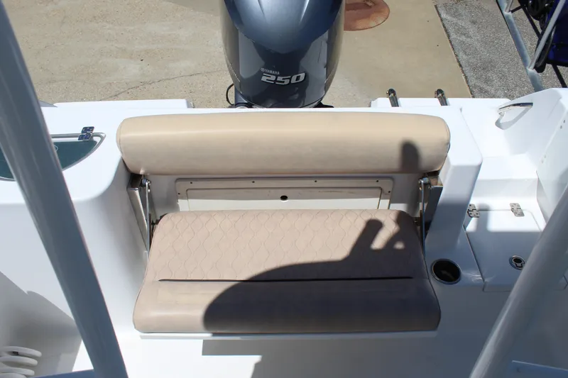 Slide: The Image of The 2019 Sportsman Open 232 Center Console features a beige rear bench seat and an outboard motor. - 13