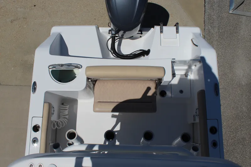Slide: The Image of The image shows the stern of a 2019 Sportsman Open 232 Center Console boat with an engine. - 29