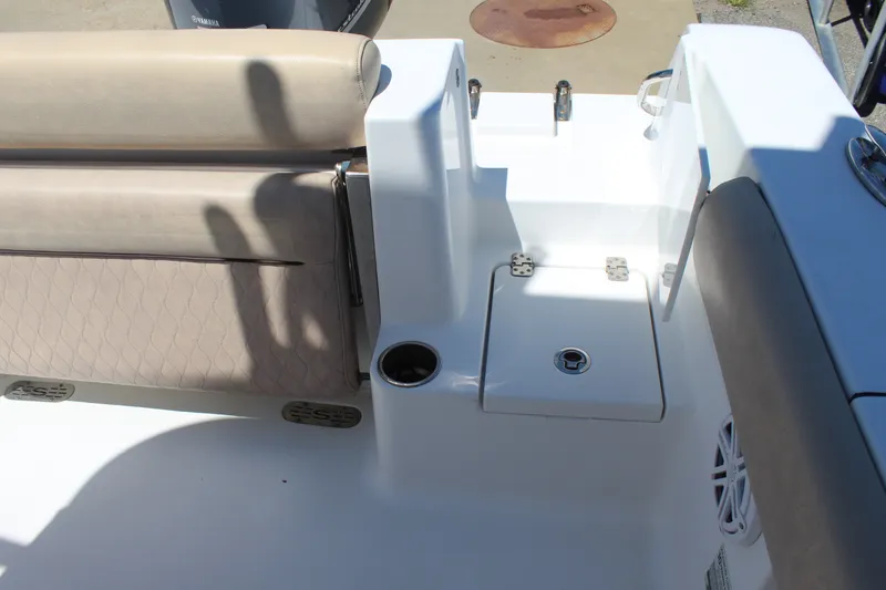 Slide: The Image of The image shows the rear area of a 2019 Sportsman Open 232 Center Console boat with seating and storage. - 11