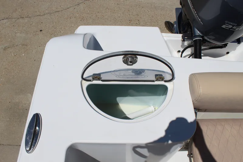 Slide: The Image of An open storage compartment on a 2019 Sportsman Open 232 Center Console boat. - 15