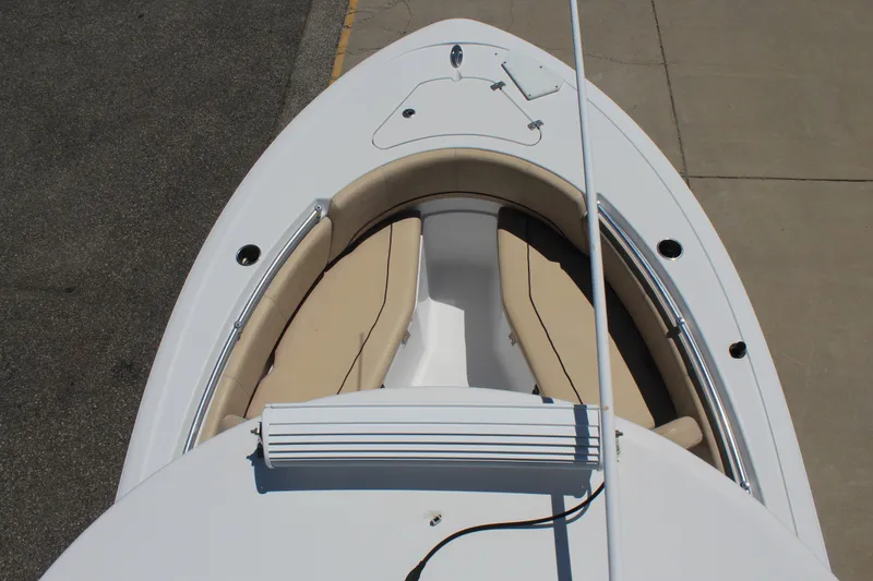 Slide: The Image of The 2019 Sportsman Open 232 Center Console features a clean, white deck with beige cushions. - 30