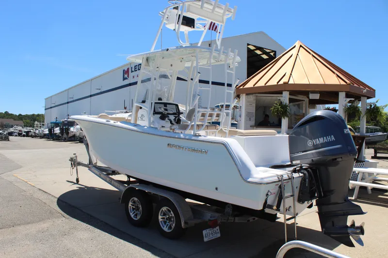 Slide: The Image of A white 2019 Sportsman Open 232 Center Console boat on a trailer in front of a building. - 5